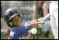 Shaquana Smith of the Jackie Robinson South Ward Little League Black Yankees of Newark, N.J., swings at the ball Sunday, June 26, 2005, during "Tee Ball on the South Lawn." White House photo by Paul Morse