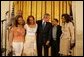 President George W. Bush celebrates Black Music Month Monday, June 6 2005, in the East Room of the White House. With him from left are artists: Reverend Donnie McClurkin; sisters Erica and Tina Campbell of Mary Mary; Smokie Norful, and Teresa Hairston, founder an publisher of Gospel Today and emcee of the event. White House photo by Krisanne Johnson