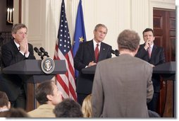 President George W. Bush is flanked by European Union President Jean-Claude Juncker, left, and European Commission President Jose Manuel Barroso as they participate in a news conference in the East Room Monday, June 20, 2005.  White House photo by Paul Morse