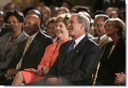 President George W. Bush, Laura Bush and HUD Secretary Alphonso Jackson, pictured at right, listen to performers during the White House reception honoring June as Black Music Month in the East Room Monday, June 6, 2005.  White House photo by Paul Morse