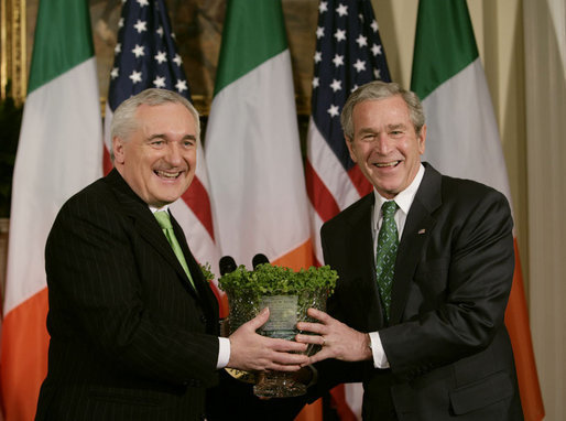 President George W. Bush is presented with a bowl of shamrocks by Ireland's Prime Minister Bertie Ahern at a ceremony in the Roosevelt Room at the White House, March 16, 2007. White House photo by Joyce Boghosian