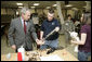 President George W. Bush talks with U.S. Army Sgt. Dennis Cline II of Memphis, Tenn., about therapy Friday, March 30, 2007, during a visit to Walter Reed Army Medical Center in Washington, D.C. Also pictured is Sgt. Cline’s wife Brooke Ann Cline. White House photo by Eric Draper