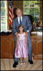 President George W. Bush poses for a photo with Catharine Aboulhouda, age 5, the 2008 March of Dimes National Ambassador, during her visit to the White House Monday, July 21, 2008, in the Oval Office. As the 2008 National Ambassador, Catharine will travel around the country with her parents, sharing her story to help other understand the seriousness of premature birth and the importance of supporting the March of Dimes' mission to help all babies be born full term and healthy. White House photo by Eric Draper
