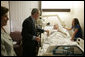 President George W. Bush shakes the hand of SPC Jeremy Goodman of Washington, N.C., as his wife, Terry Goodman, looks on Wednesday, Oct. 5, 2005, during a visit by the President and Mrs. Bush to Walter Reed Army Medical Center in Washington D.C. White House photo by Paul Morse