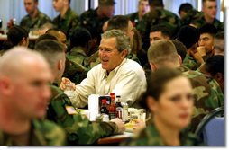 President George W. Bush and Laura Bush, not pictured, sit down for lunch with soldiers at Fort Campbell, Ky., Thursday, March 18, 2004. "Here, at one of America’s vital military bases, you’ve built a strong community of people who care about each other, and share the challenges and rewards of army life. America is grateful. America is proud of our military families," said the President in his remarks."   White House photo by Tina Hager