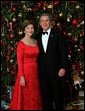 Celebrating the 2003 holiday season, President George W. Bush and Laura Bush pose for a Christmas portrait in front of the White House Christmas Tree. White House photo by Eric Draper