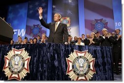 President George W. Bush reacts to the response of the audience before speaking to the Veterans of Foreign Wars convention in Cincinnati, Ohio, Monday, Aug. 16, 2004.  White House photo by Paul Morse