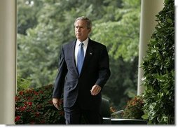 President George W. Bush enters the Rose Garden where he talks about America's intelligence reforms Monday, Aug. 2, 2004.   White House photo by Paul Morse