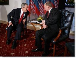 President George W. Bush leans in to speak with Russia President Vladimir Putin Thursday, Feb. 24, 2005 during a photo opportunity in Bratislava, Slovakia. The meeting of the two leaders marked the last during President Bush's five-day European trip.   White House photo by Eric Draper
