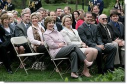 Mrs. Laura Bush and Secretary Margaret Spellings of the Department of Education, smile as they listen to remarks by President George W. Bush during Rose Garden ceremonies Thursday, April 26, 2007, honoring the 2007 Teachers of the Year.  White House photo by Eric Draper