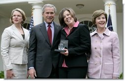 President George W. Bush is joined by Secretary of Education Margaret Spellings and Mrs. Laura Bush as they congratulate the 2007 National Teacher of the Year, Andrea Peterson, during ceremonies Thursday, April 26, 2007, in the Rose Garden. Mrs. Peterson is a music teacher at Monte Cristo Elementary School in Granite Falls, Washington.  White House photo by Eric Draper