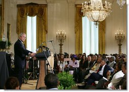 President George W. Bush welcomes guests to the East Room of the White House Friday, June 22, 2007, to join in a celebration of Black Music Month, focusing on the music of hip hop and R &B artists.  White House photo by Chris Greenberg