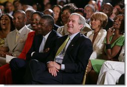 President George W. Bush, entrepreneur Bob Johnson, left, and invited guests respond to entertainers Friday, June 22, 2007 in the East Room of the White House, in celebration of Black Music Month.  White House photo by Chris Greenberg