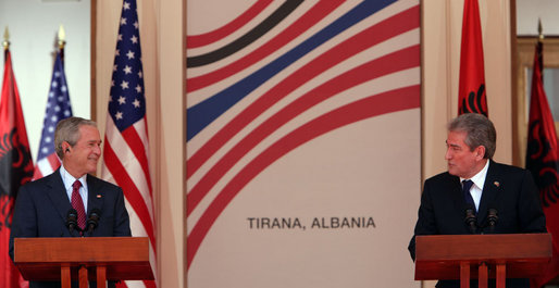 President George W. Bush smiles during a remark Sunday, June 10, 2007, by Albania's Prime Minister Sali Berisha during a joint press availability in Tirana, Albania. White House photo by Chris Greenberg