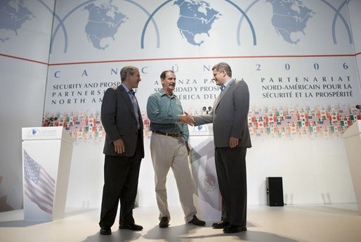 President George W. Bush, Mexico's President Vicente Fox, center, and Canadian Prime Minister Stephen Harper, right, meet to shake hands following their joint news conference, Friday, March 31, 2006 in Cancun, Mexico, at the conclusion of their summit meeting. White House photo by Eric Draper
