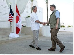 President George W. Bush shakes hands with Canadian Prime Minister Stephen Harper, Thursday, March 30, 2006 in Cancun, Mexico, in their first meeting since Harper was elected Prime Minister. President Bush is participating in a three-day summit with the leaders of Mexico and Canada. White House photo by Kimberlee Hewitt