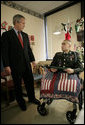 President George W. Bush shares a moment with U.S. Army Cpl. Shane Parsons after presenting him with a Purple Heart Friday, Dec. 22, 2006, at Walter Reed Army Medical Center where the Fostoria, Ohio, soldier is recovering from injuries received in Operation Iraqi Freedom. White House photo by Eric Draper