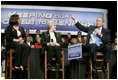 President George W. Bush talks with grandmother Margaret Valdez, center, and her granddaughter Jessica Valdez during a Conversation on Strengthening Social Security in Albuquerque, N.M., Tuesday, March 23, 2005.