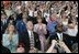 Laura Bush applauds as she folllows the launch of the Space Shuttle Discovery, Tuesday, July 26, 2005, at the Kennedy Space Center in Cape Canaveral, Florida. Mrs. Bush is joined by Florida Governor Jeb Bush, right, and NASA Astronaut Scott Altman, left. 