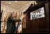 President George W. Bush smiles as he waves goodbye to the crew of the Space Shuttle Discovery Tuesday, Aug. 2, 2005, during a phone call from the Roosevelt Room of the White House. Before bidding the crew Godspeed and telling them to "get back to work," the President thanked them for being "risk-takers for the sake of exploration."