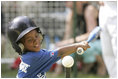 Shaquana Smith of the Jackie Robinson South Ward Little League Black Yankees of Newark, N.J., swings at the ball Sunday, June 26, 2005, during "Tee Ball on the South Lawn."