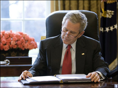 President George W. Bush reads over a draft of his State of the Union speech in the Oval Office Tuesday morning, Jan. 31, 2006, in preparation for the annual address to the nation that evening.