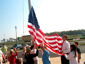 Congressman Chandler helping students raise the U.S. flag.