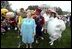 Accompanied by all sorts of story book characters, Lynne Cheney the host of the 2003 White House Easter Egg Roll, addresses the media on the South Lawn Monday, April 21, 2003. "But most of all, we are proud of all of you, the men and women who serve our country, who keep our country free," said Mrs. Cheney in her opening remarks welcoming U.S. military families to the event.