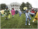 Children slip through a race with their Easter eggs during the traditional race on the South Lawn. Although rainy weather cut short the event, children and their parents made many colorful memories to brighten up a gray, gloomy day.^M