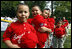 Players of the Cramer Hill Little League Red Sox of Camden, New Jersey hold their hats over their hearts during the singing of the National Anthem at the 2008 Tee Ball on the South Lawn Season Opener Monday, June 30, 2008, on the South Lawn of the White House.