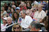 President George W. Bush joins honorary tee ball commissioner and two-time Olympic gold medalist Michele Smith on the South Lawn sidelines of the 2007 White House Tee Ball season opener Wednesday, June 27, 2007. The game matched the Red Wings of Luray, Virginia against the Bobcats of Cumberland, Maryland.