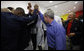 President George W. Bush huddles with members of the U.S. Olympic Men's Basketball Team Sunday, Aug. 10, 2008, during a visit with the team prior to their game against China at the 2008 Summer Olympic Games in Beijing. Former President George H.W. Bush is seen at right. White House photo by Eric Draper