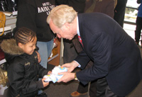 Senator Lieberman helps children pick out shoes at Payless Shoes in Bridgeport.