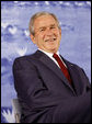 President George W. Bush smiles during an introduction by his father, former President George H.W. Bush Friday, Aug. 8, 2008, during the dedication of the United States Embassy in Beijing. White House photo by Eric Draper