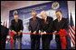 President George W. Bush and former President George H.W. Bush join U.S. Ambassador to China Sandy Randt and Dai Bingguo, People’s Republic of China State Councilor, as they participate in a ribbon-cutting ceremony Friday, Aug. 8, 2008, at the U.S. Embassy in Beijing. White House photo by Eric Draper