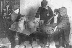 Jewish children making boxes in the Glubokoye ghetto.