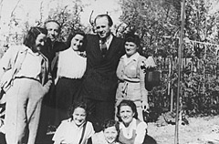 Oskar Schindler (second from the right) poses with a group of Jews he rescued one year after the war (1946).