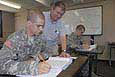 Army Prep School instructor Tom Gandy goes over coursework with Pvt. Kyle Rucker. Rucker, who dropped out of high school when his father passed away, was able to enter the Army thanks to a new program which provides Soldiers their GED before being shipped out to Basic Combat Training. (Photo by Chris Rasmussen)