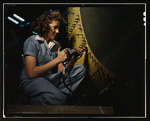 Woman riveter at work on Consolidated bomber, Consolidated Aircraft Corp., Fort Worth, Texas