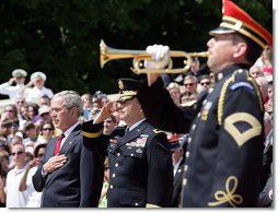 President George W. Bush is accompanied by Major General Richard J. Rowe Jr., commander of the Military District of Washington, right, as he holds his hand over his heart during the playing of taps at the Tomb of the Unknowns during a Memorial Day ceremony Monday, May 26, 2008 at Arlington National Cemetery in Arlington, VA. White House photo by Chris Greenberg