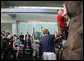 President George W. Bush, left, watches as double amputee Lance Cpl. Matt Bradford, who is also blind, climbs a wall, during President Bush’s visit Thursday, Nov. 8, 2007 to the physical therapy and training area for wounded soldiers at the Center for The Intrepid at the Brooke Army Medical Center in San Antonio, Texas. White House photo by Eric Draper