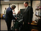 President George W. Bush presents the Purple Heart to U.S. Army Spc. John C. Hoxie of Philippi, W.Va., during a visit Thursday, Dec. 20, 2007, to Walter Reed Army Medical Center in Washington, D.C., where the soldier is recovering from injuries suffered in Operation Iraqi Freedom. Looking on is the soldier's father, David Hoxie. White House photo by Joyce N. Boghosian