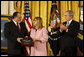 President George W. Bush leads the applause in honor of Petty Officer Michael A. Monsoor after presenting the Congressional Medal of Honor posthumously to his parents, George and Sally Monsoor, during ceremonies Tuesday, April 8, 2008, at the White House. The 25-year-old Navy SEAL was killed in Iraq in 2006 after he threw himself on a grenade to save his fellow SEALS when they came under attack while on duty in Ramadi. White House photo by Eric Draper