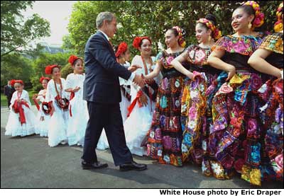 President George W. Bush greets dancers before their performance during Cinco de Mayo festivities at the White House. White House photo by Eric Draper.