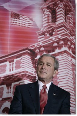 President George W. Bush stands before a backdrop of Ellis Island, Monday, March 27, 2006, at the Naturalization Ceremony for new U.S. citizens at the Daughters of the American Revolution Administration Building in Washington. President Bush welcomed the new U.S. citizens, telling them that each generation of immigrants brings a renewal to our national character and adds vitality to our culture.  White House photo by Eric Draper
