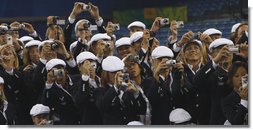 United States Olympians take photos of President George W. Bush as he speaks to the athletes Friday, Aug. 8, 2008, prior to the start of the Opening Ceremony for the 2008 Summer Olympic Games in Beijing. White House photo by Eric Draper