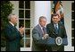 President George W. Bush discusses America's policies regarding Cuba as Secretary of State Colin Powell, left, and Secretary of Housing and Urban Development Mel Martinez stand by his side in the Rose Garden Friday, Oct. 10, 2003. "We will increase the number of new Cuban immigrants we welcome every year," said the President. "We are free to do so, and we will, for the good of those who seek freedom. Our goal is to help more Cubans safely complete their journey to a free land." White House photo by Tina Hager