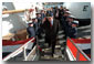 President Bush salutes as he disembarks the ship after his tour Jan. 25. "When it comes to securing our homeland, and helping people along the coast, the Coast Guard has got a vital and significant mission," said the President in his remarks at nearby Southern Maine Technical College. "And, therefore, the budget that I send to the United States Congress will have the largest increase in spending for the Coast Guard in our nation's history." White House photo by Eric Draper