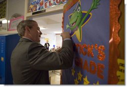 President George W. Bush signs a classroom door during his visit with teachers and students at North Glen Elementary School in Glen Burnie, Md., Monday, Jan. 9, 2006. White House photo by Kimberlee Hewitt