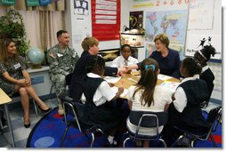 Mrs. Laura Bush shakes hands with student Taylor McIntyre, during her visit with students at the Good Shepherd Nativity Mission School, Thursday, Nov. 1, 2007 in New Orleans, a Helping America's Youth visit with Big Brother and Big Sisters of Southeast Louisiana. Captain Richard T. Douget, second from left, is a Big Brother to Taylor McIntyre. White House photo by Shealah Craighead